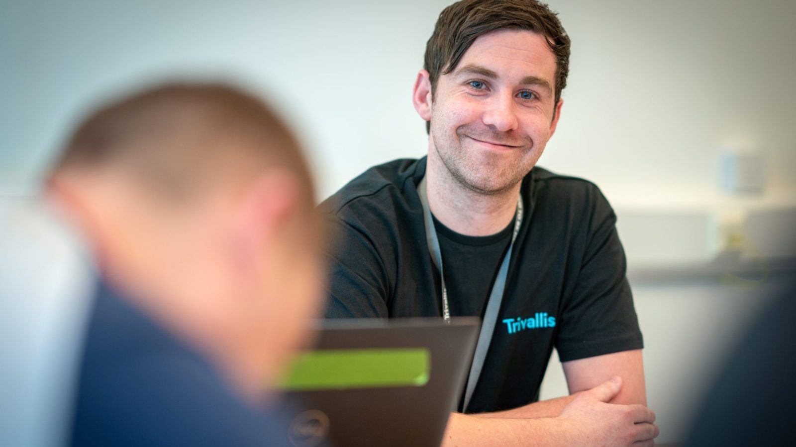 Trivallis Housing Landlord Wales A smiling man wearing a black t-shirt with the logo 