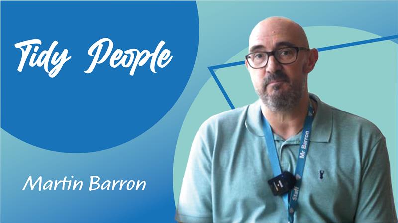 Trivallis Housing Landlord Wales A man wearing glasses and a pale green shirt with a lanyard labeled "Mr. Barron" sits in front of a blue and teal background. Text on the image reads "Tidy People" and "Martin Barron.