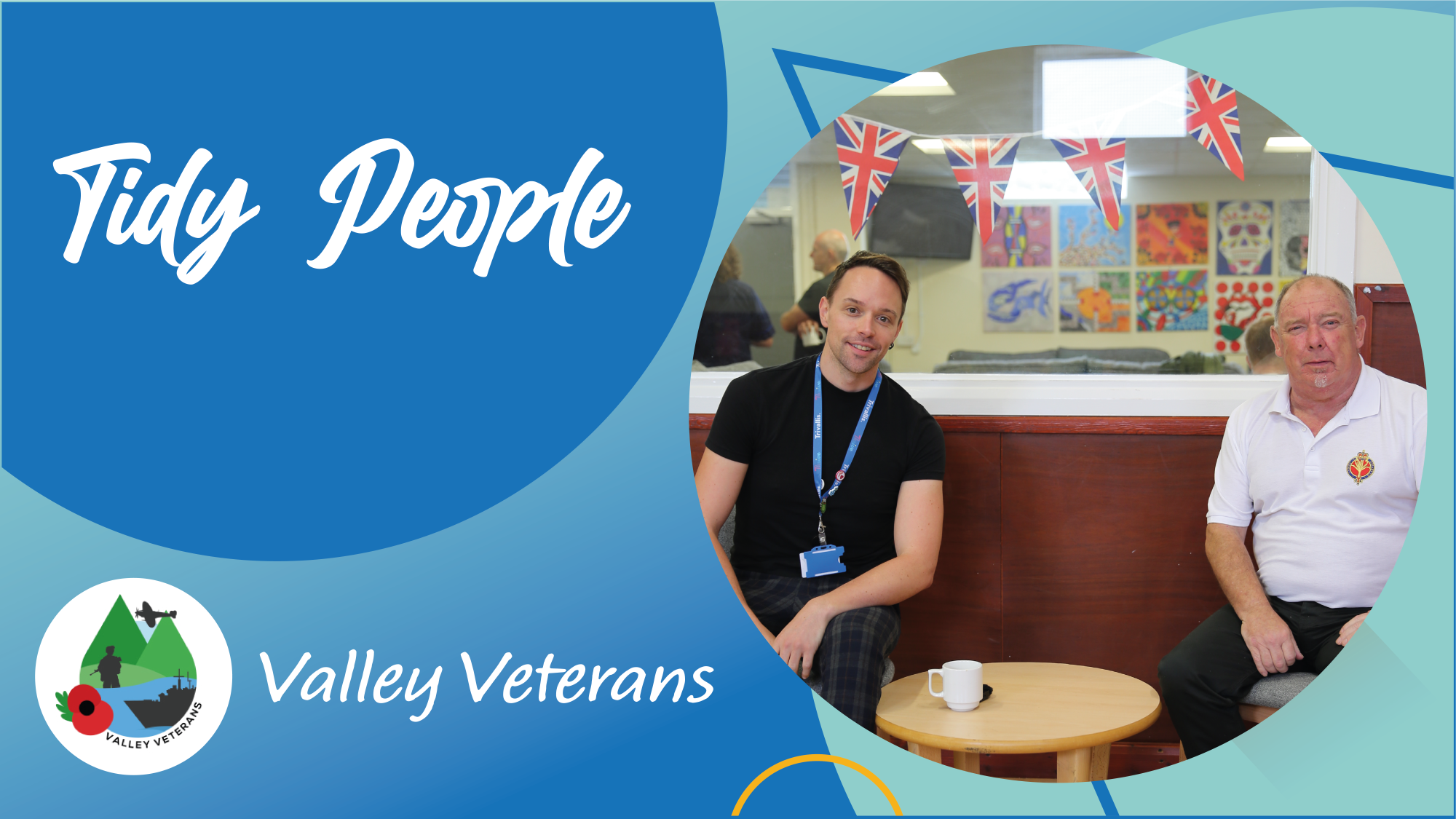 Trivallis Housing Landlord Wales Two men sit at a small round table with a white mug in front of them. Behind them are patriotic bunting and colorful wall art. The text reads "Tidy People Valley Veterans" with a logo in the bottom left corner.
